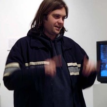 Nathan Shafer's Kickstarter icon, a waist length image of him gesturing while speaking and wearing a black jacket
