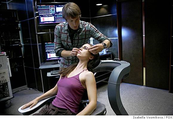 Topher Brink (Fran Kranz) works with Echo (Eliza Dushku) who is seated in "The Chair" on the set of Dollhouse