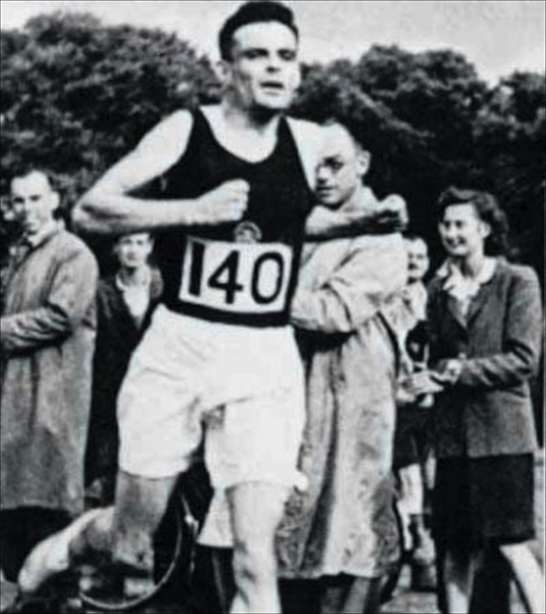 Image of Alan Turing running in shorts and tank top, with number 140 pinned to the front of his shirt