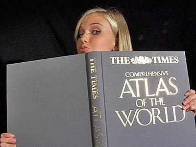 Caitlin Upton peering over the top of The Times Atlas of theWorld