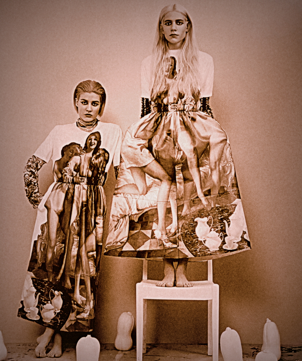 Vaneeesa Blaylock & Stacey Giachino stand in an antique, selenium toned image wearing dresses with photo prints on them.