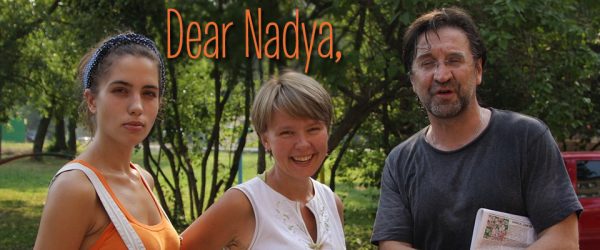 Dear Nadya.  Nadya Tolokno. Nadezhda Andreyevna Tolokonnikova. Наде́жда Андре́евна Толоко́нникова. Nadya Tolokno with 2 friends in a wooded area. Tolokno wears an orange top and white overalls.  Her hair is up in a blue bandanna. The friends smile for the camera, yet Tolokno seems more pensive.