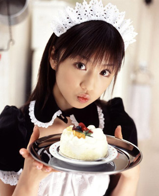 Asian French Maid holding a tiny cake on a tiny platter